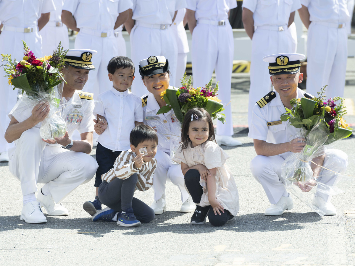 Des enfants de la communauté canado-japonaise offrent des fleurs au Contre-amiral Yasushige Konno, commandant de l'Escadron d'entraînement du Japon (à gauche), au Capitaine de vaisseau Miho Otani, commandant du navire japonais Kashima (au centre), et au Commodore Ikezaki Hiroyuki, commandant du navire japonais Hatakaze (à droite) lors de leur visite à la BFC Esquimalt dans le cadre de la croisière d'entraînement outre-mer du Japon en 2023. Photo : Aviateur Conor Munn, technicien en imagerie des Forces armées canadiennes