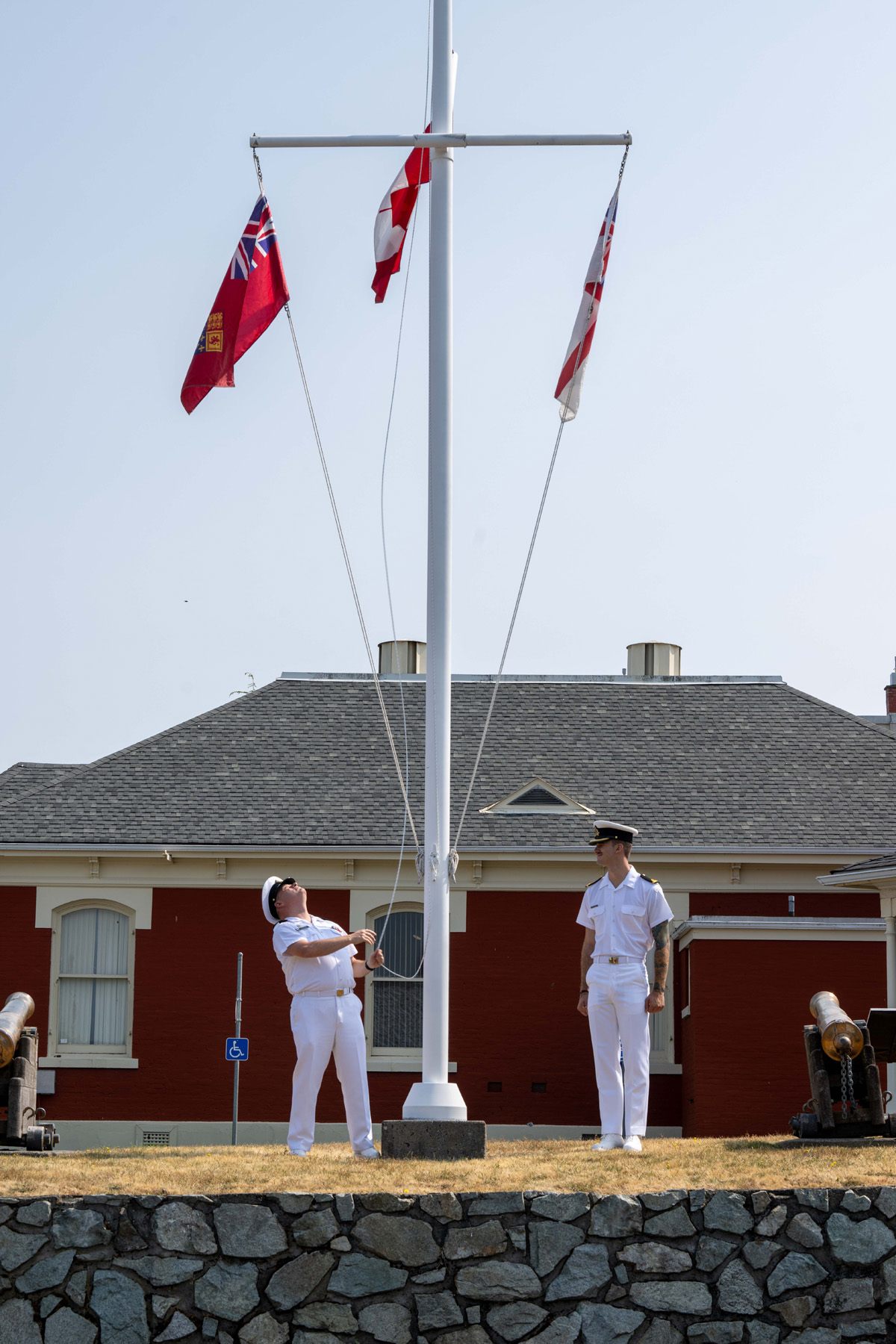 Base Chief Petty Officer, Chief Petty Officer 1st Class Alden Darragh (on the left) breaks the Pennant of the incoming Base Commander Captain (Navy) Kevin Whiteside, CD. To signify the Change of Command from one Base Commander to the next. The flag will be flown each day the Base Commander is on base. The ceremony was held at the Base Museum Bldg N-27, Canadian Forces Base Esquimalt, On July 7th, 2023. Photo: Cpl Tristan Walach, MARPAC Imaging Services, Esquimalt