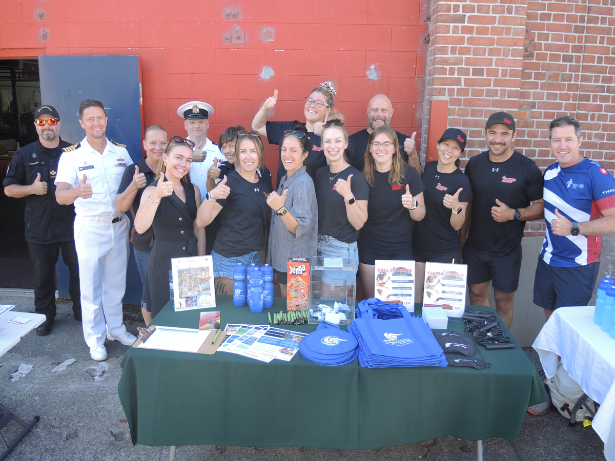 Staff of Personnel Support Programs (PSP) gather for a group photograph during a celebration for the reopening of the Dockyard Gym, Aug. 15, 2023. Credit: Peter Mallett/Lookout Newspaper