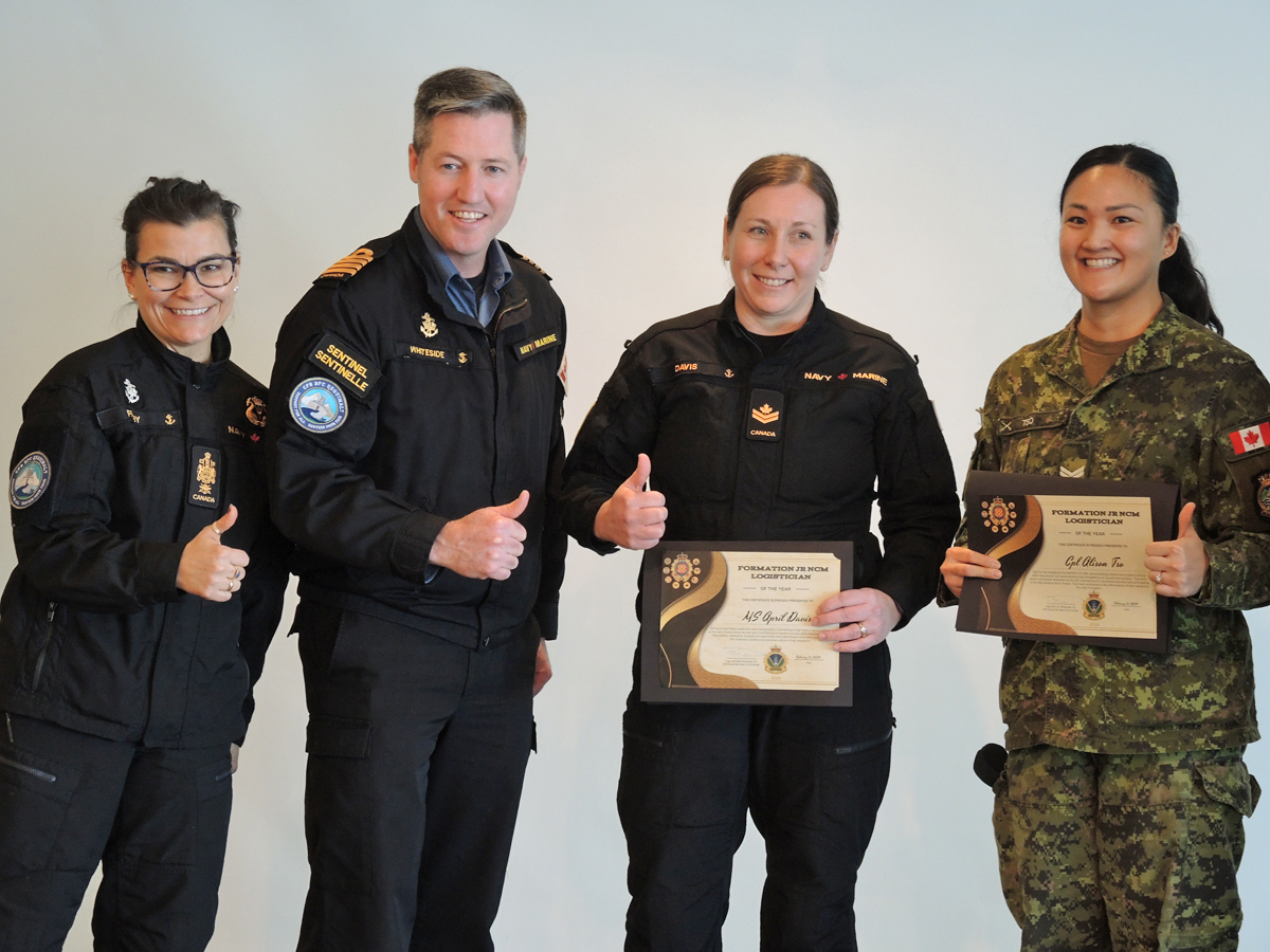 (Left) Chief Petty Officer First Class Susan Frisby, Base Chief, and Captain (Navy) Kevin Whiteside, Base Commander, present Master Sailor April Davis, Base Orderly Room, and Corporal Alison Tso, MARPAC/JTF(P) HQ, with the Formation Logistics Junior Non-Commissioned Member Award. All photos: Peter Mallett, Lookout Newspaper