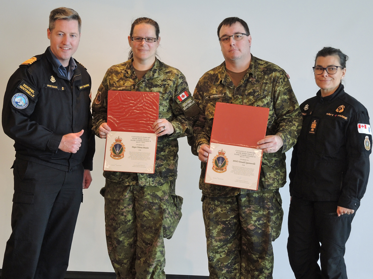 (Left) Captain (Navy) Kevin Whiteside, Base Commander, and (right) Chief Petty Officer First Class Susan Frisby, Base Chief, present Logisticians Major Weena Boutin, Transport and Electrical Mechanical Engineering Officer and Master Warrant Officer Donald Quenneville, Base Logistics Acting Systems Control Officer, with a certificate of recognition for organizing this year's 56th anniversary party.