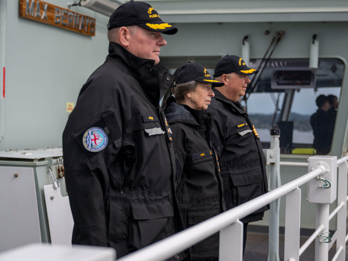 Her Royal Highness, Princess Anne, The Princess Royal, Honourary Commodore-in-Chief of the Canadian Fleet Pacific (middle), Commodore David Mazur, Commodore of Canadian Fleet Pacific (left), and Commander Collin Forsberg, Captain of HMCS Max Bernays, gather on the ship’s bridge wing to prepare for arrival to CFB Esquimalt on May 4.