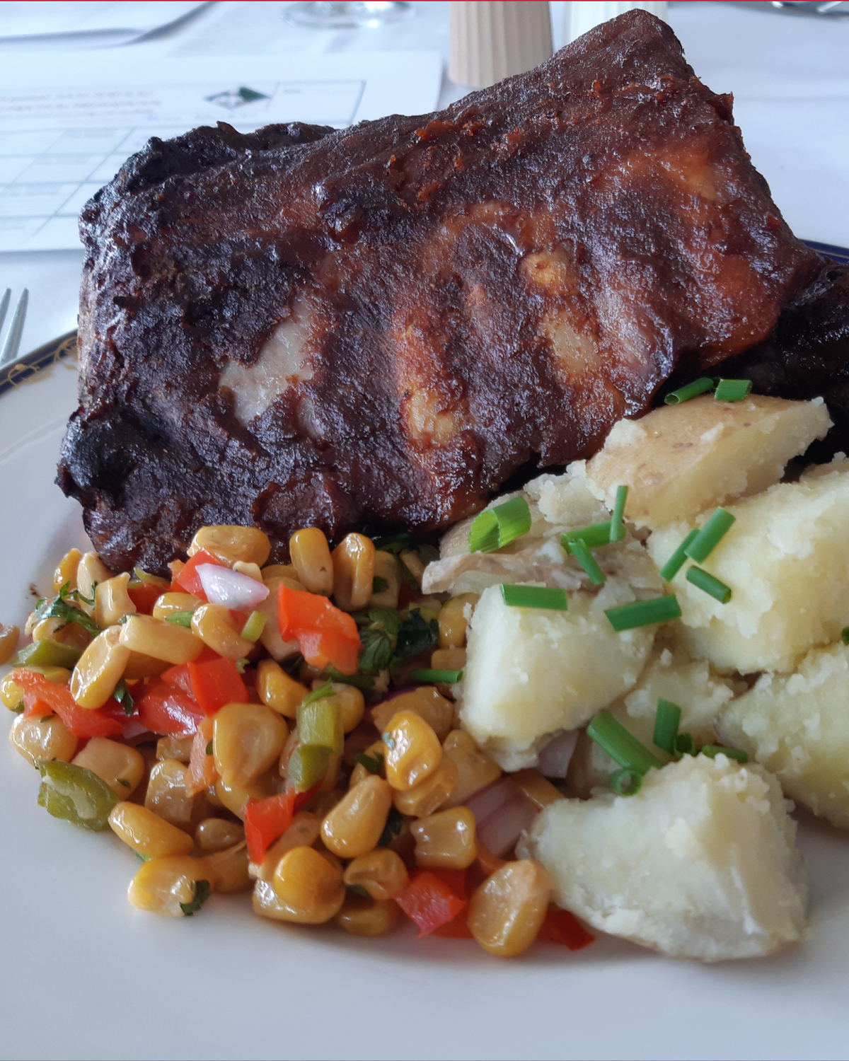 The main course of a Confirmation Dinner served by Sailor 2nd Class Trey Pennington at Venture Galley, which included slow oven-baked BBQ ribs, shaken garlic potatoes topped with chives, and a grilled corn medley. Photos: Peter Mallett/Lookout Newspaper
