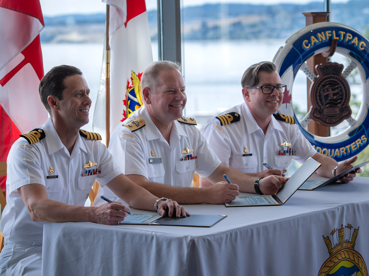 Captain (Navy) Mark O’Donohue, Commodore David Mazur and Commander Sam Patchell sign off on documents to confirm the Change of Appointment for Commander Patchell as Deputy Commander of Canadian Fleet Pacific, June 25. Photos: Master Sailor Valerie LeClair.