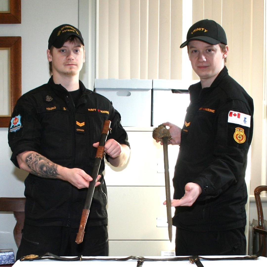 Aidan and Bailey Young, view the naval sword and accoutrements associated with HMS Royal Oak at the CFB Esquimalt Naval & Military Museum.
Photo: Paul Seguna