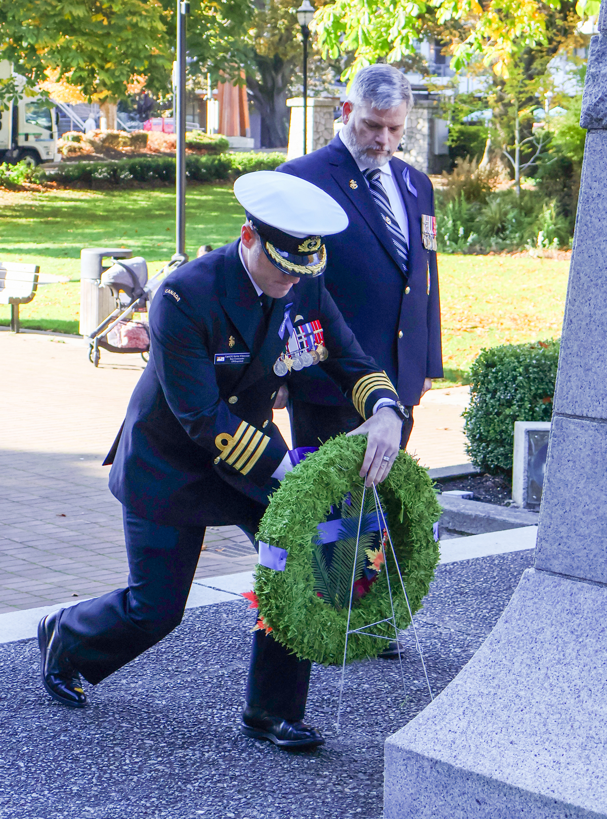 Caption: Captain (Navy) Kevin Whiteside, CFB Esquimalt Base Commander lays a wreath at Memorial Park in Esquimalt in honour of those who died during the HMCS Kootenay explosion, accompanied by CPO1 (ret'd) Al Darraugh, who was onboard that fateful day.