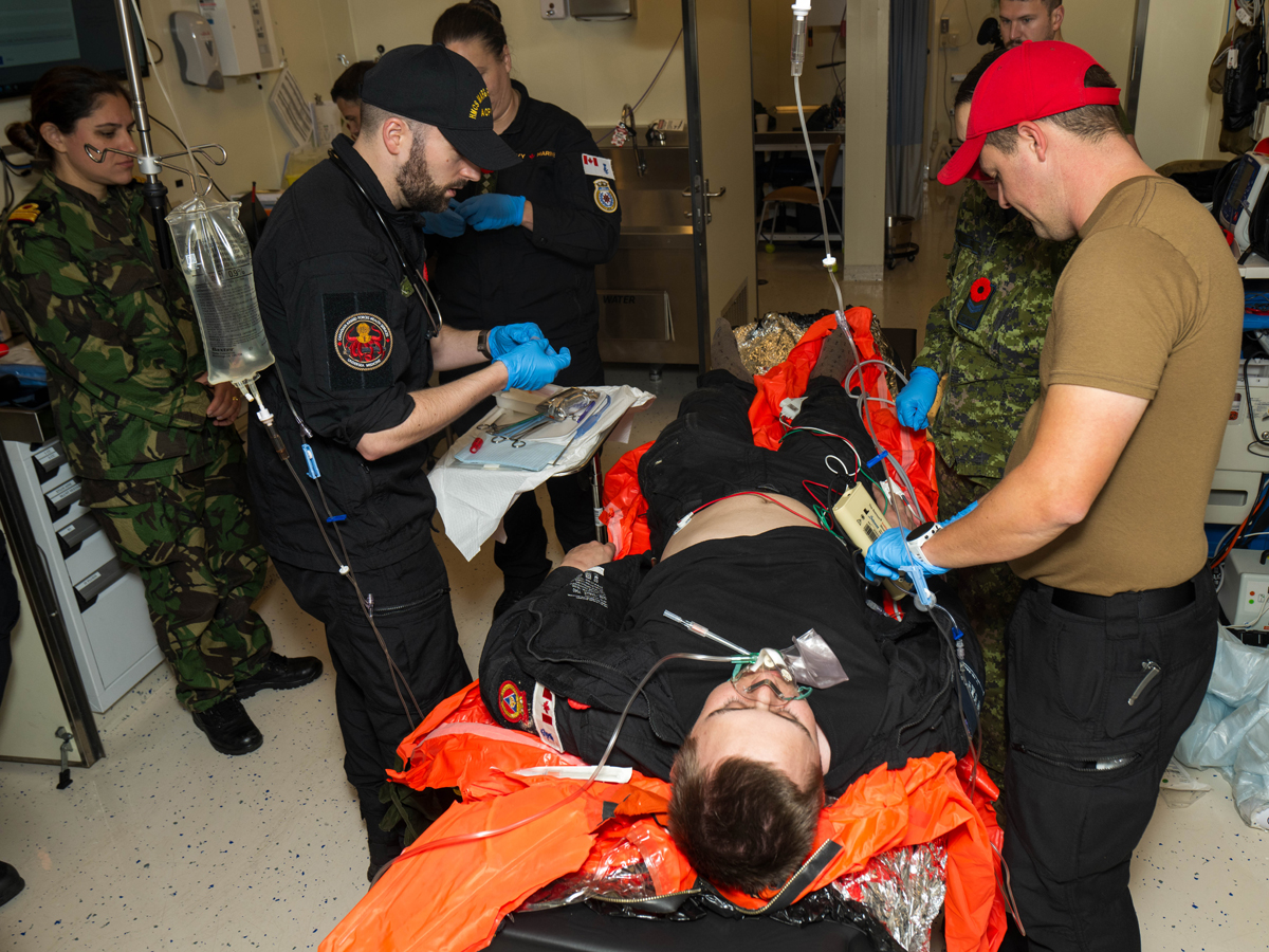 Participants of the NATO Submarine Medical Officer Course are assessed while treating simulated casualties suffering from decompression sickness and bodily injury aboard His Majesty Canadian Ship Max Bernays while alongside C-jetty of Canadian Forces Base Esquimalt in November. Photo: Sailor 1st Class Brendan McLoughlin, MARPAC Imaging Services.
