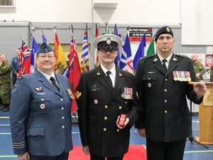 Master Sailor (MS) Guay receiving his Canadian Decoration 3 Clasp. From Left to right: Lieutenant-Colonel L.J. Rediger, MS S. Guay, and School Chief Warrant Officer M.R. Lanctot. Photo supplied